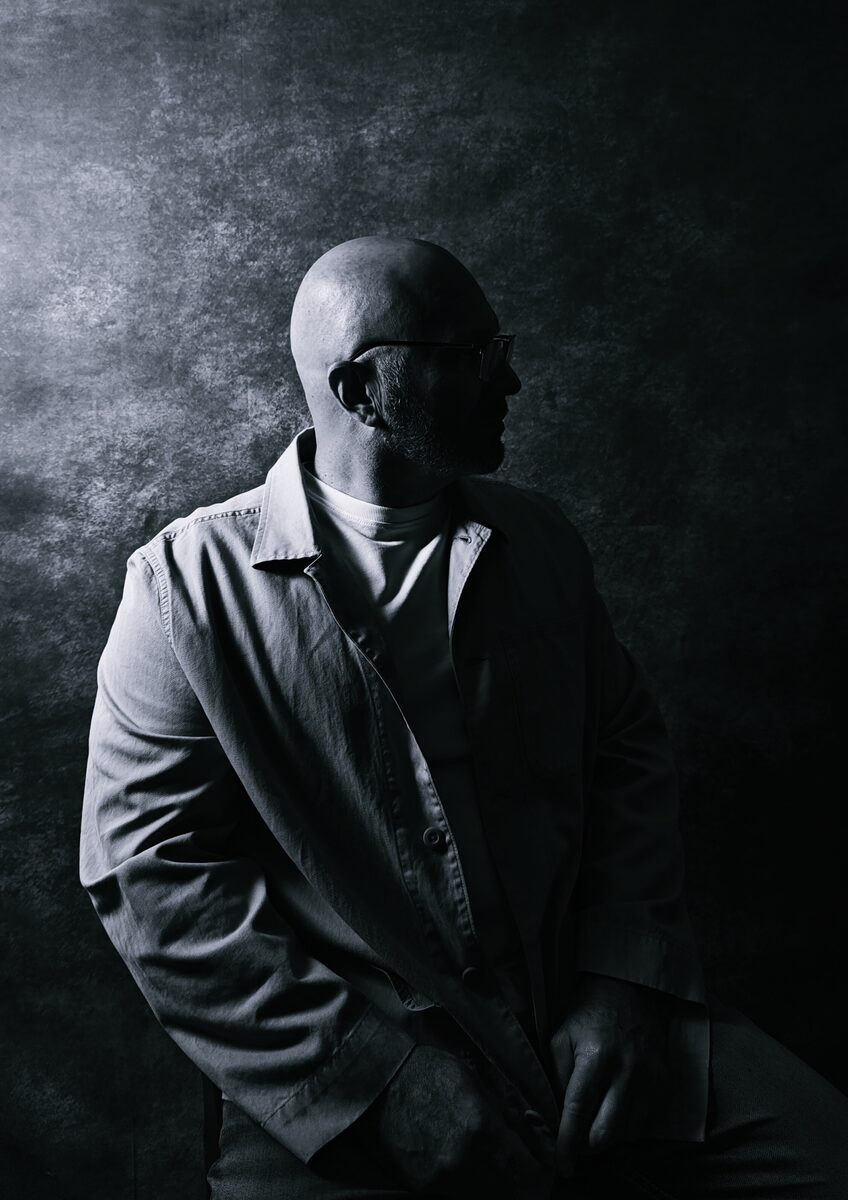 Max Theodor, photographed in profile against a dark backdrop